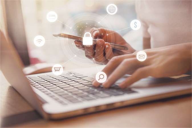  Hands using a laptop with icons representing digital security and communication floating above, symbolizing online privacy and data protection.